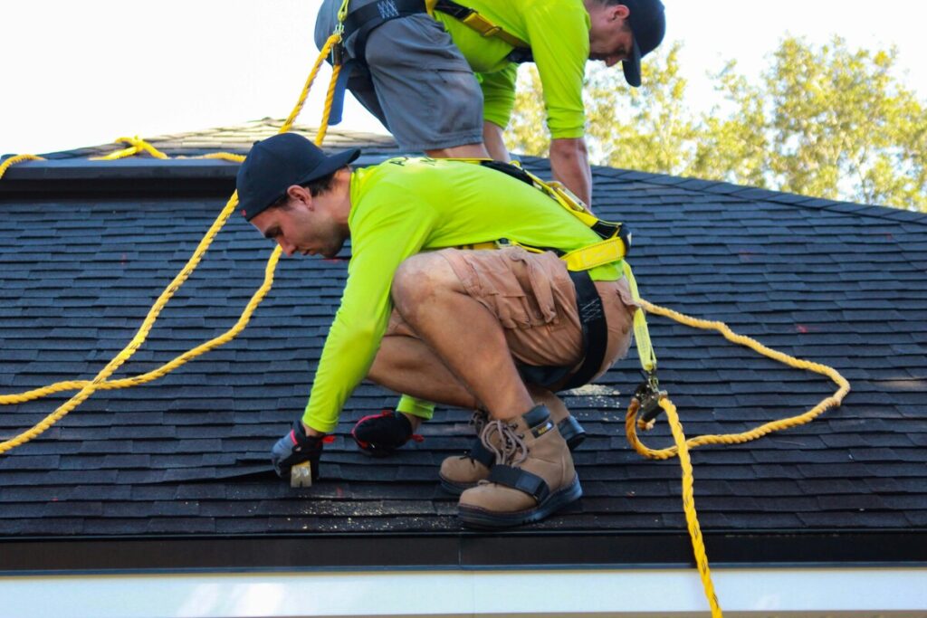 Two workers doing roof repair